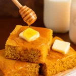Moist Sweet Cornbread with butter and honey drizzle