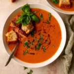 Roasted Tomato Soup in a bowl with basil garnish