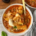 TikTok Lasagna Soup in bowl with cheese and basil