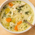 Creamy Lemon Chicken Orzo Soup in rustic bowl