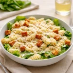 Caesar Pasta Salad in bowl with romaine and croutons