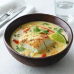 Coconut Lime Fish Soup in bowl with lime and cilantro
