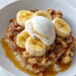 Southern Banana Cobbler in white dish with ice cream