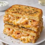 A delicious Cheesy Garlic Bread Shrimp Grilled Cheese with Monterey Jack sliced in half.