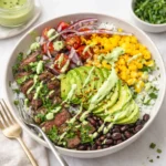A delicious Cilantro Lime Steak and Rice Bowl with avocado and crema.