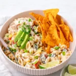 Creamy Taco Pasta Salad in a white bowl with Doritos.