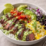A colorful Easy Cilantro Lime Steak Bowl with grilled steak and avocado.