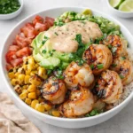 Grilled Shrimp Bowl with Avocado and Corn Salsa on a wooden table
