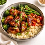 A vibrant Healthy Sticky Chicken Bowl with glazed chicken and fresh vegetables.