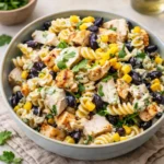 High Protein BBQ Chicken Pasta Salad in a white bowl on a wooden table
