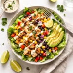 A delicious Honey Hot Chicken Salad topped with spicy glazed chicken and ranch dressing.