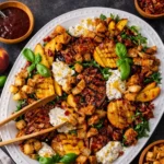 BBQ Chicken Salad with Grilled Peaches and Burrata on a platter