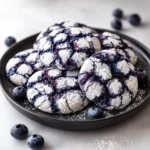 Freshly baked Blueberry Crinkle Cookies on a plate