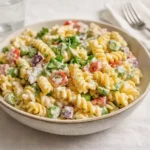 A bowl of Creamy Pasta Salad with rotini and fresh vegetables.