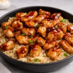 Delicious Honey BBQ Chicken Rice in a large skillet with mixed vegetables and green onions.