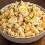Creamy Deviled Egg Pasta Salad in a bowl with paprika and dill.