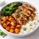 A delicious Hot Honey Chicken Bowl with roasted vegetables and avocado.