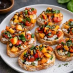 Close-up of Quick Peach Bruschetta with Whipped Ricotta on a wooden board.